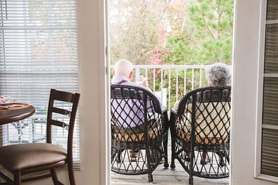 Two residents enjoying a serene moment on a balcony