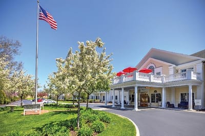 Exterior view of Commonwealth Senior Living with gardens.