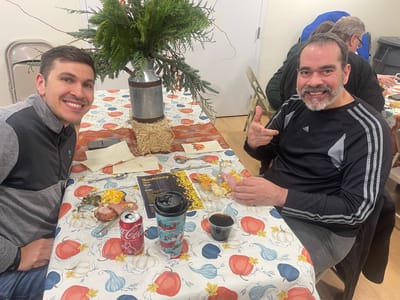 Two residents enjoying a meal at a festive table