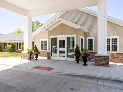 Entrance of a senior living facility with landscaped planters