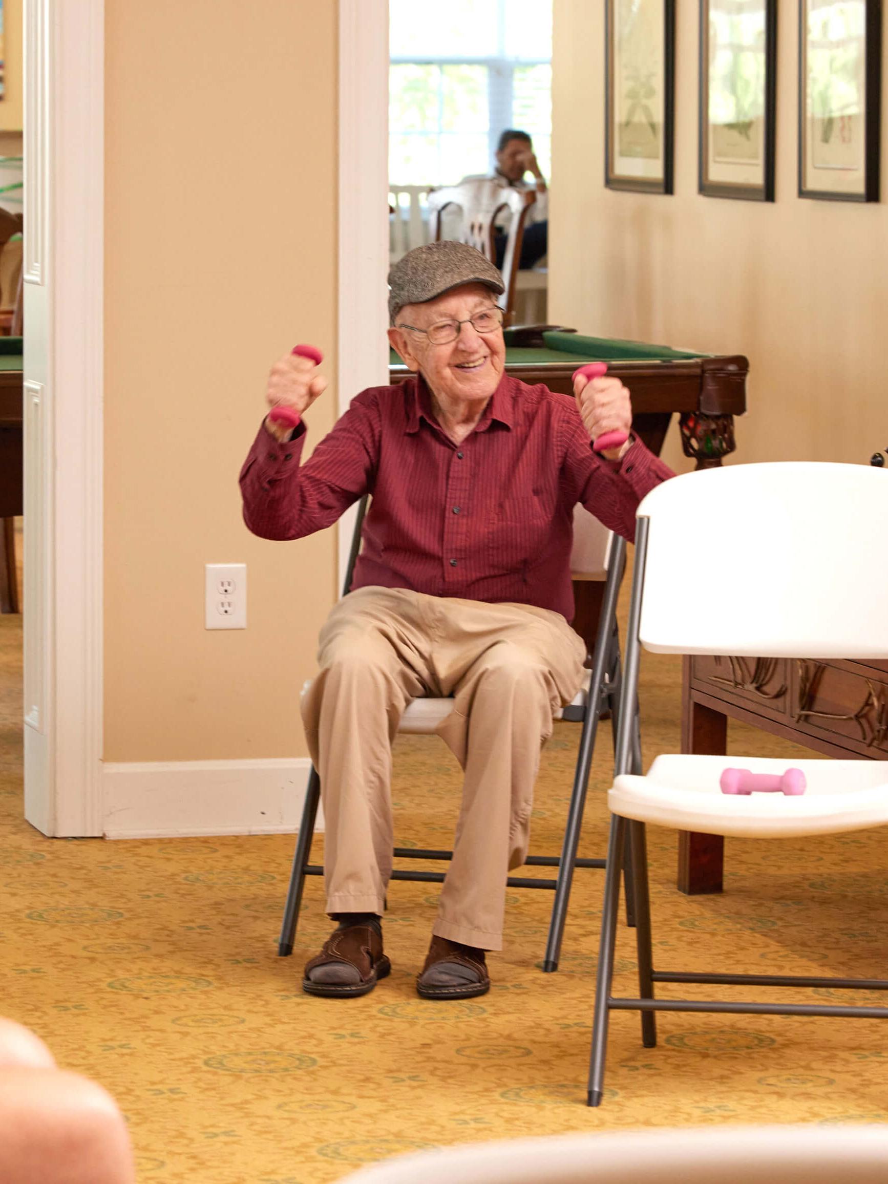Resident exercising with weights in a common area