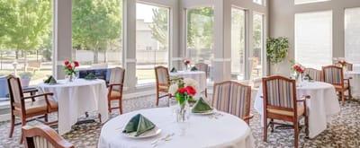 Bright dining room with tables set for meals