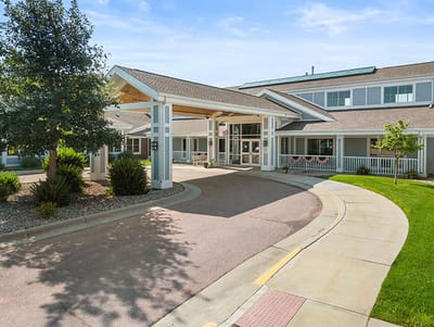 Good Samaritan Society Sioux Falls Village, Nursing Home in Sioux Falls, SD — Entrance of a senior living facility with landscaped grounds