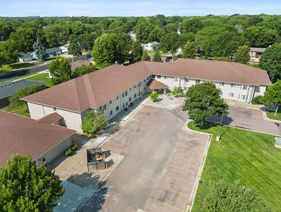 Good Samaritan Society Sioux Falls Village, Nursing Home in Sioux Falls, SD — Aerial view of a senior living facility with parking lot