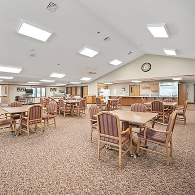 Good Samaritan Society Sioux Falls Village, Nursing Home in Sioux Falls, SD — Dining area with tables and chairs in a senior living facility