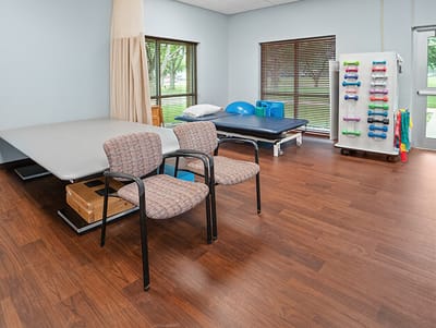 Good Samaritan Society Sioux Falls Village, Nursing Home in Sioux Falls, SD — Therapy room with chairs and exercise equipment