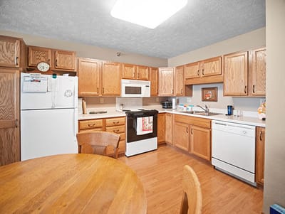 Good Samaritan Society Sioux Falls Village, Nursing Home in Sioux Falls, SD — Modern kitchen with wooden cabinets and appliances