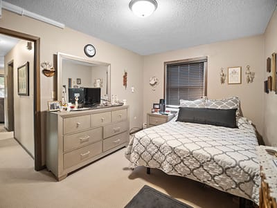 Good Samaritan Society Sioux Falls Village, Nursing Home in Sioux Falls, SD — Cozy senior living bedroom with neutral decor and furniture