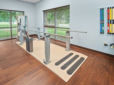 Good Samaritan Society Sioux Falls Village, Nursing Home in Sioux Falls, SD — Rehabilitation gym with parallel bars and therapy equipment