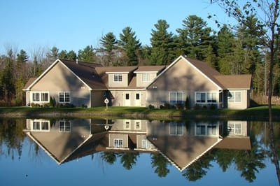Exterior view of a facility by a pond