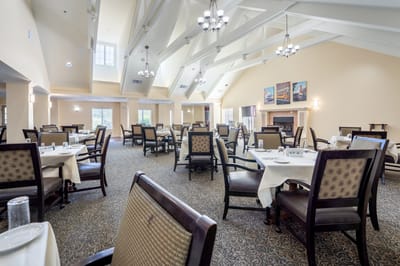 Dining room with tables and chairs set up for meals