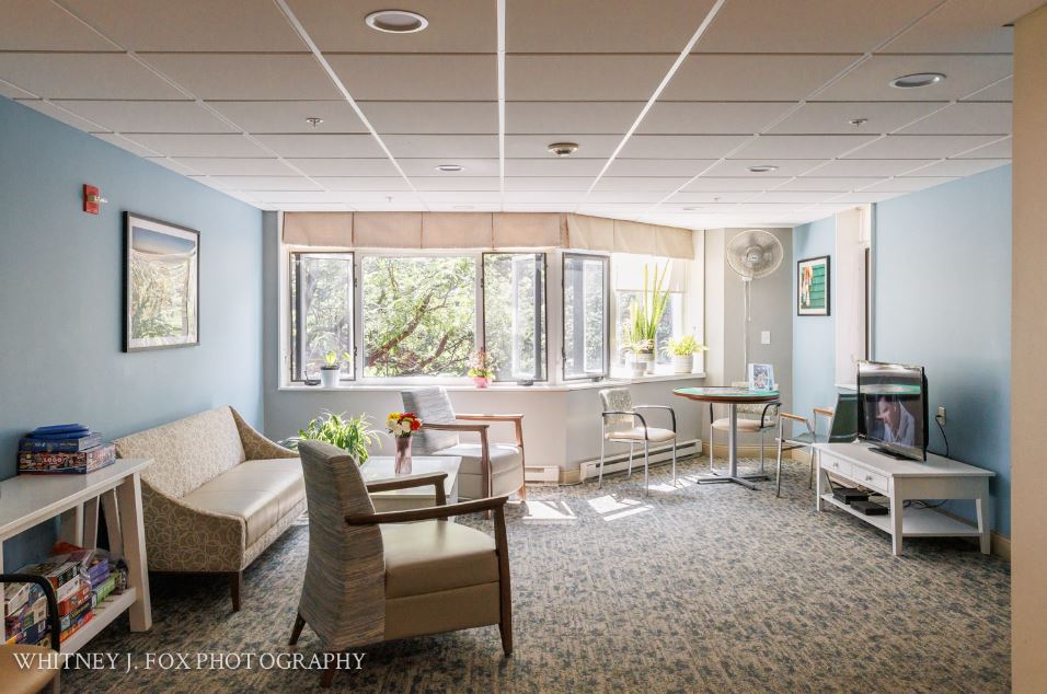 Bright common area with seating and large windows