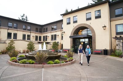 Residents walking near the main entrance and fountain