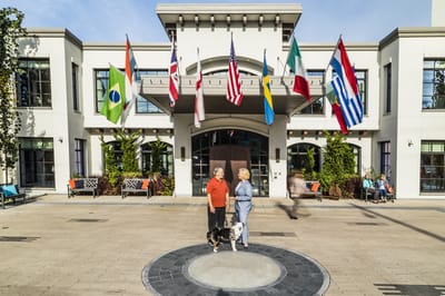 Residents standing in front of facility with flags