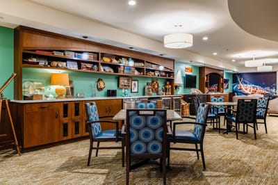 Well-decorated common area with seating and shelves
