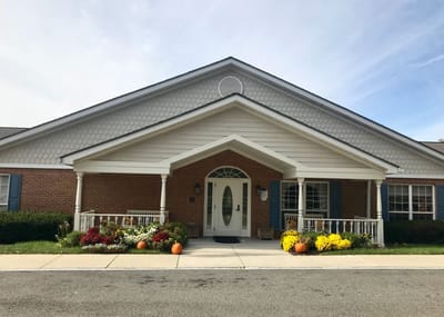 Exterior view of a senior living facility with flowers
