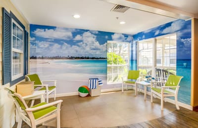Bright interior lounge with beach mural and seating