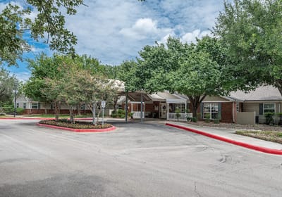 Front entrance of a senior living facility with landscaping