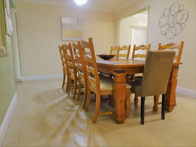 Dining area with large wooden table and chairs