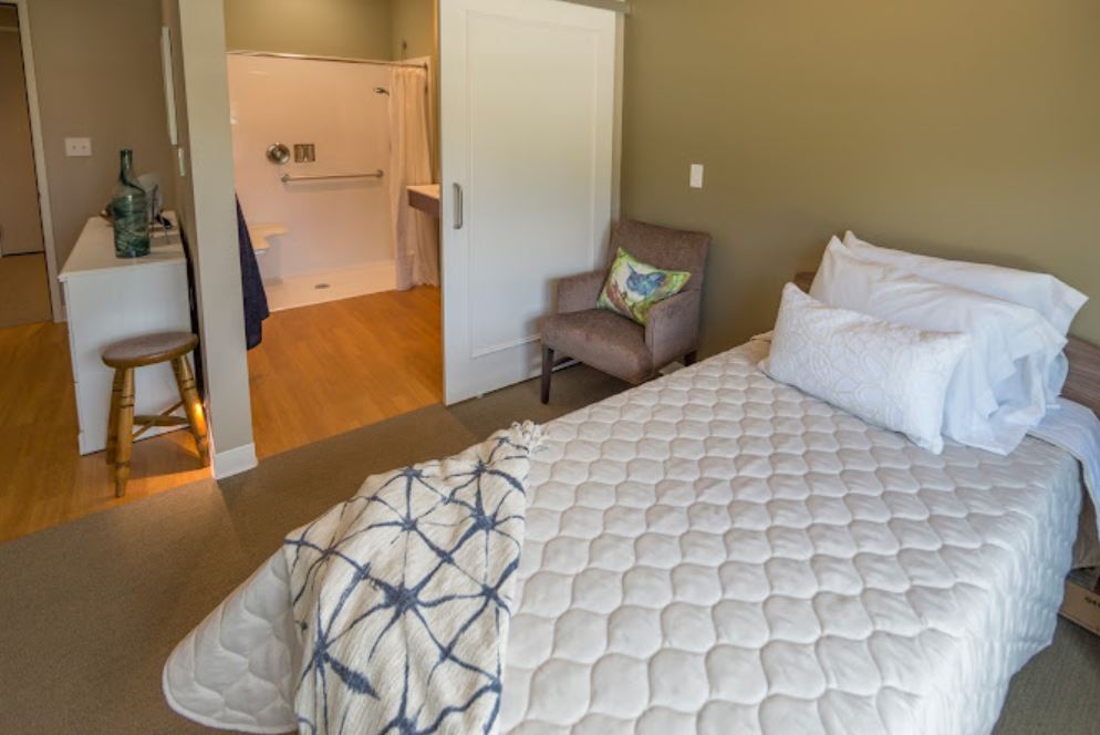 Comfortable resident room with a bed and chair