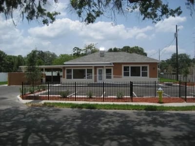Exterior view of a senior living facility with landscaped garden