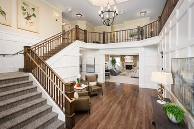 Interior view of a welcoming lobby with stairs and seating