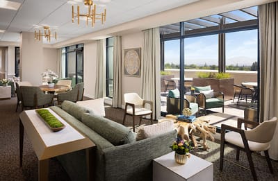 Bright common area with seating and outdoor view