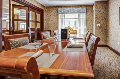 Dining room setup with wooden tables and chairs