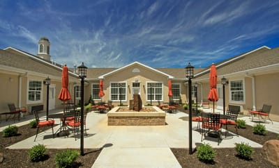 Well-maintained outdoor courtyard with seating and umbrellas