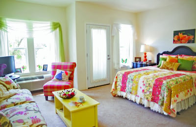 Brightly decorated resident room with floral accents