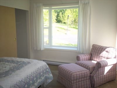 Cozy resident room with a bed and armchair