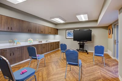 An activity room set up for a class with chairs and equipment