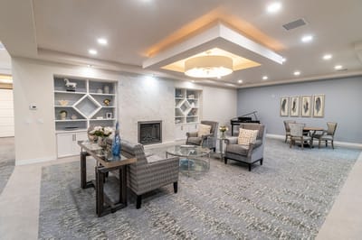 Common area with seating and piano in a senior living facility