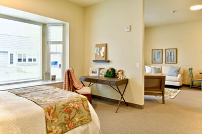 Cozy resident room with light decor and seating area