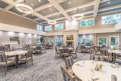 Dining area with tables and chairs in a spacious room