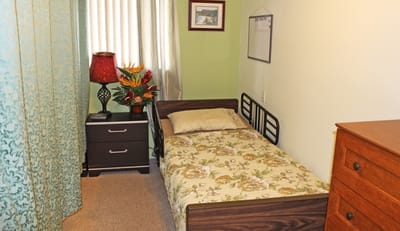 A private resident room with a bed and decor