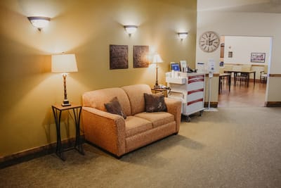 A cozy seating area with a couch and lamps
