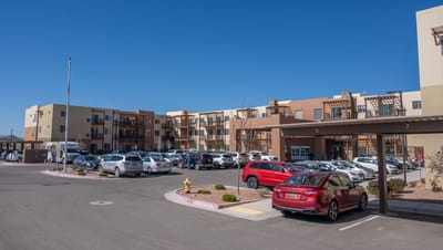 Exterior view of Las Soleras Senior Living with parking