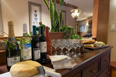 A selection of wines and snacks on a wooden table