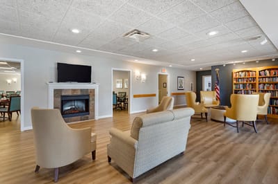 Bright common area with seating and a fireplace