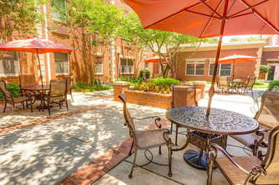 Outdoor seating area with tables and umbrellas