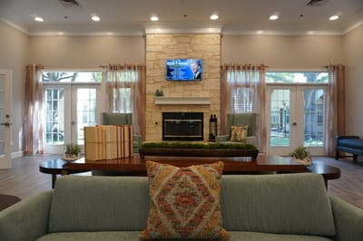 Bright and inviting common area with seating and fireplace