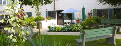 Gardens and seating area in front of the facility