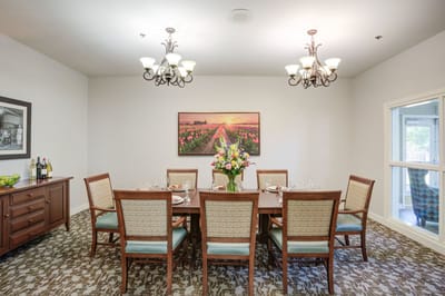 Elegant dining room setting with flowers and chairs