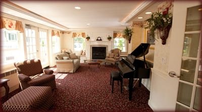 Bright common area with seating and a piano