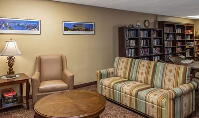 Bright common area with seating and bookshelves