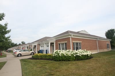 Exterior view of a senior living facility with landscaping