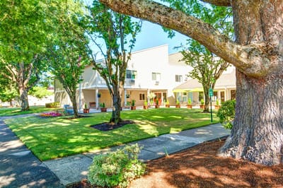 Exterior view of a senior living facility with landscaped gardens