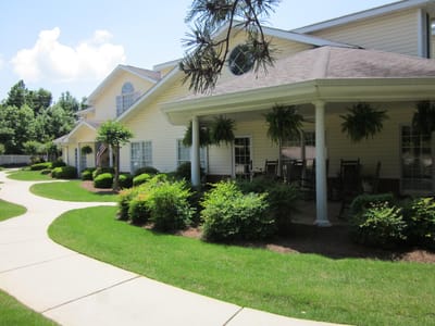 Exterior view of a senior living facility with landscaped garden