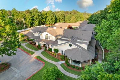 Aerial view of a senior living facility surrounded by trees